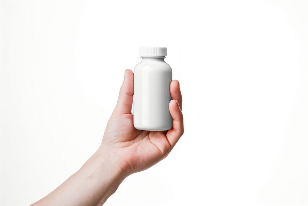 A hand holding a supplement bottle white background refreshment drinkware. AI generated Image by rawpixel.