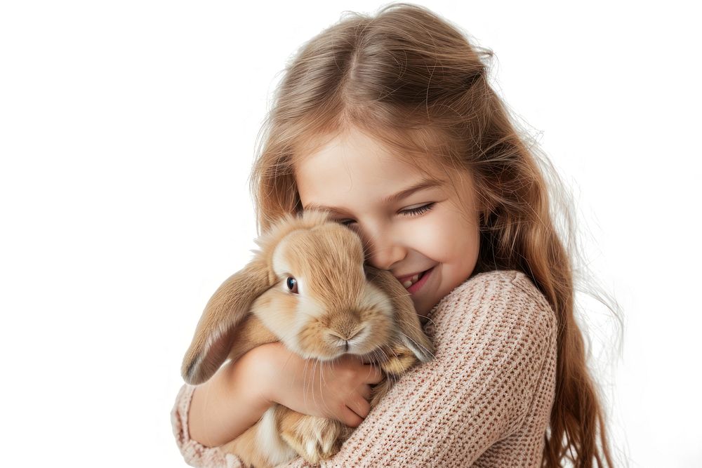 A young girl hugging a rabbit mammal animal child.