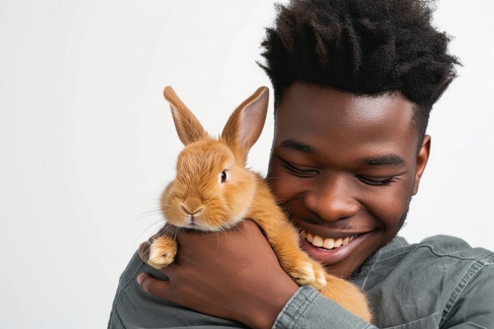 African-American man hugging a rabbit portrait mammal animal.