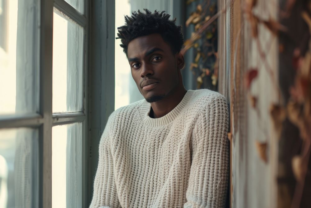 Black male sweater contemplation architecture.