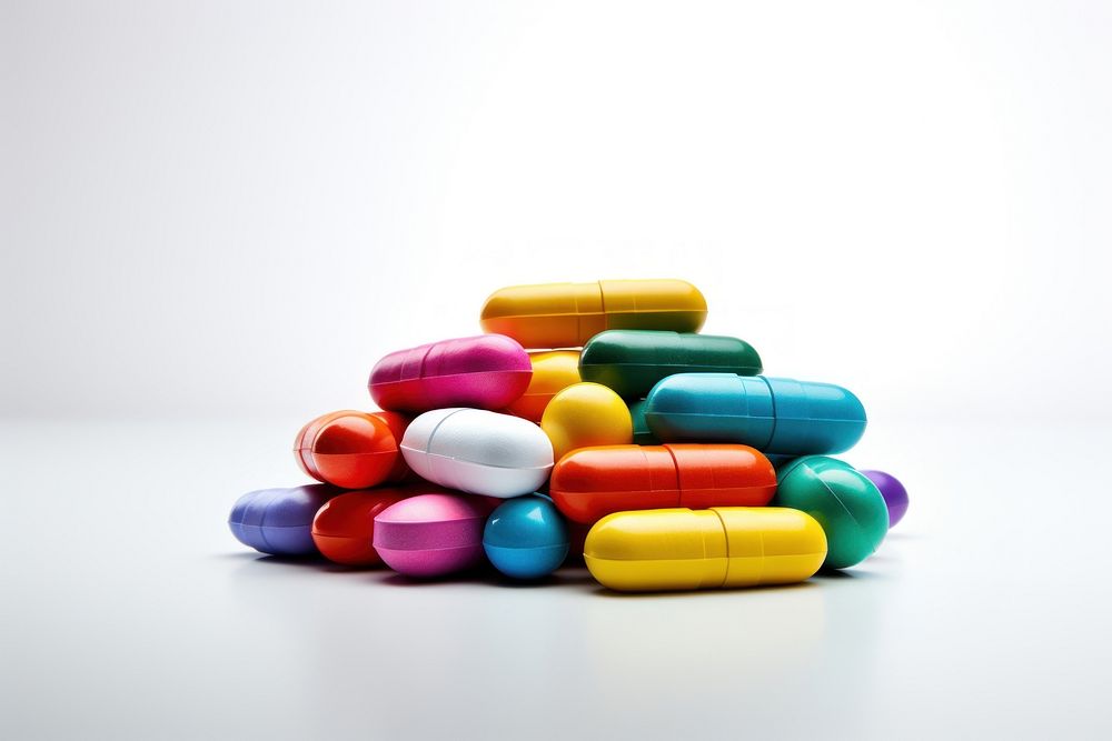 Stacked colorful medicine tablets capsule pill white background. AI generated Image by rawpixel.