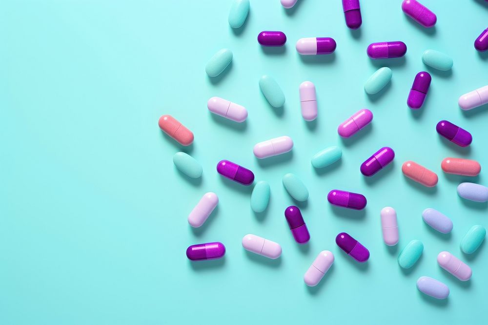 Colorful medicine pills capsule purple green.