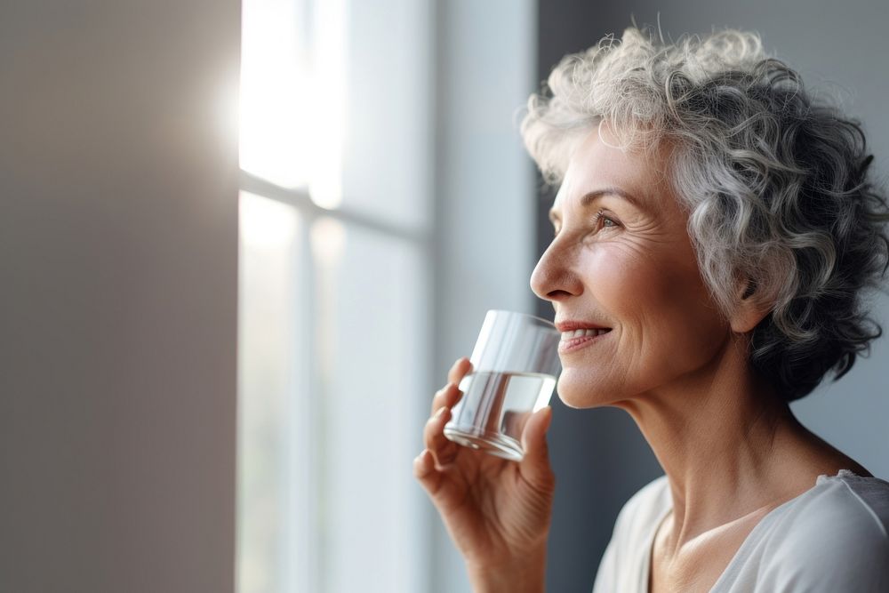 Mature woman drinking water adult contemplation refreshment. AI generated Image by rawpixel.