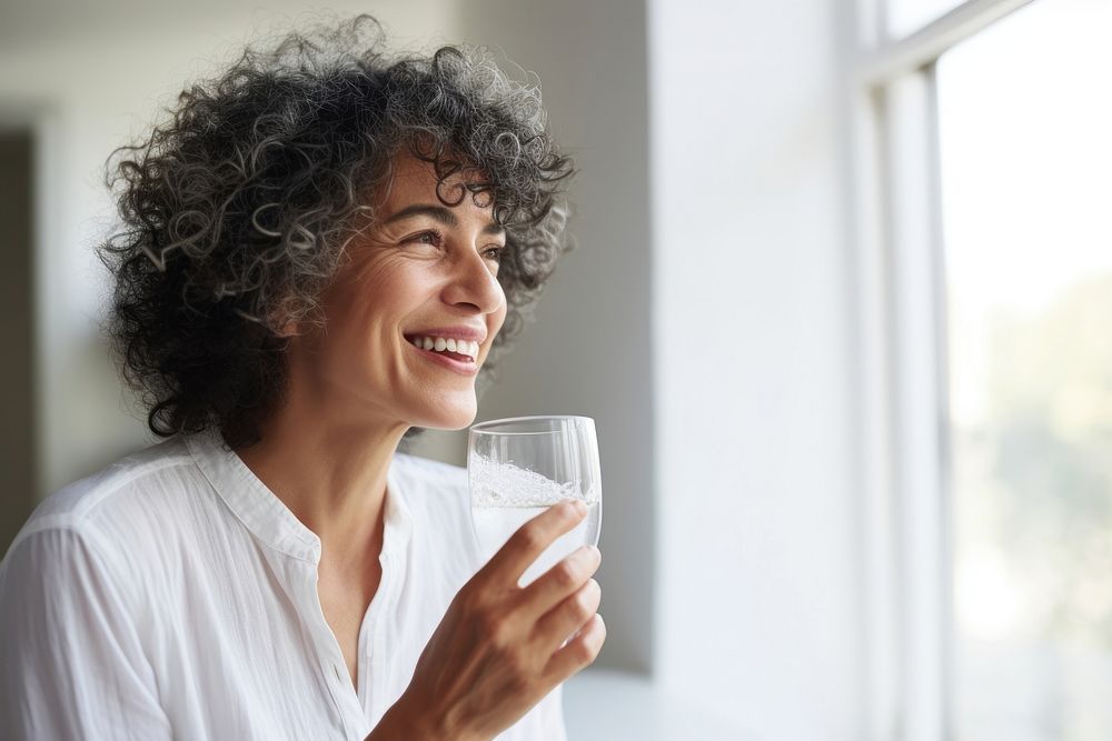 Woman drinking water laughing smile happy. AI generated Image by rawpixel.