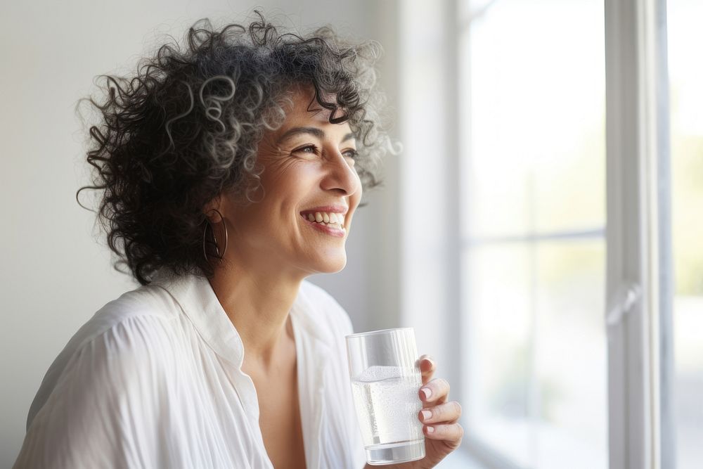 Woman drinking water laughing smile adult. AI generated Image by rawpixel.