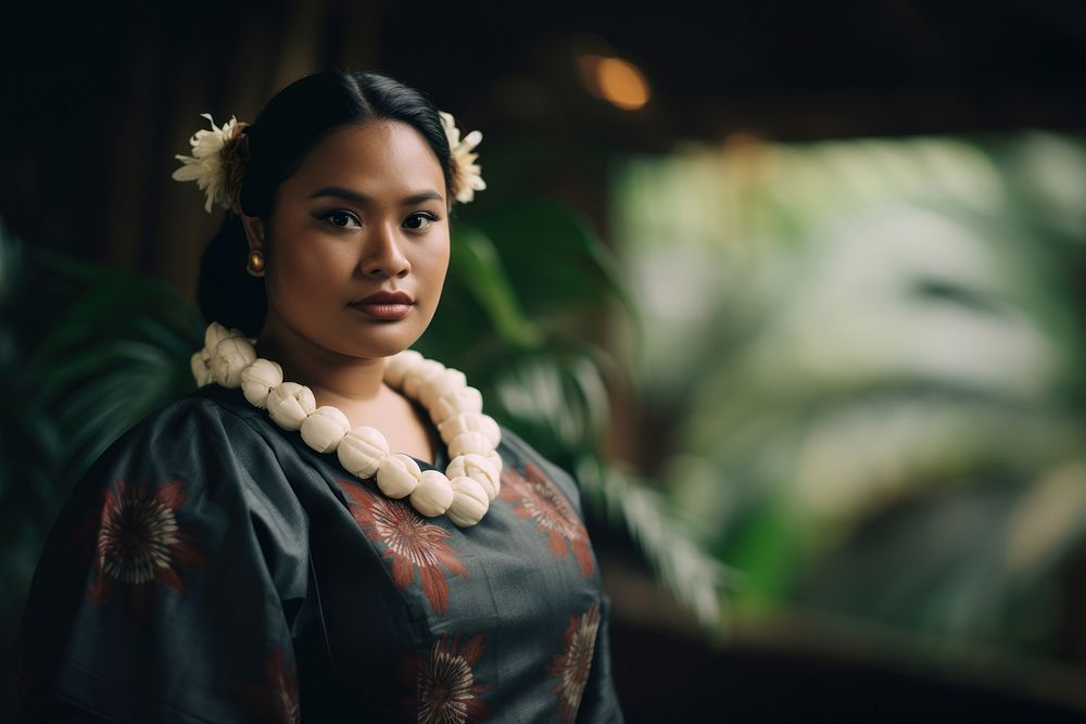 A chubby Micronesian woman in traditional cloth necklace jewelry contemplation.