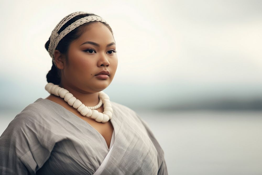 A chubby Micronesian woman in traditional cloth portrait necklace jewelry.