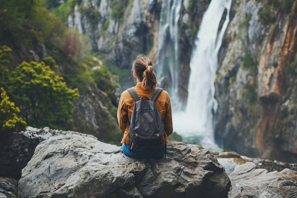 Trekking woman waterfall landscape backpack.