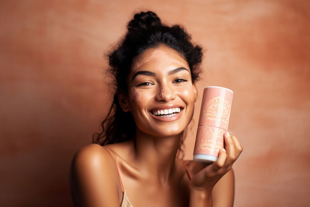 A Micronesian womans with skincare product laughing smile happy.