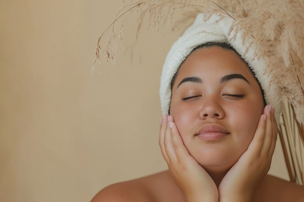 Chubby Tonga woman doing skincare routine relaxation hairstyle headshot.