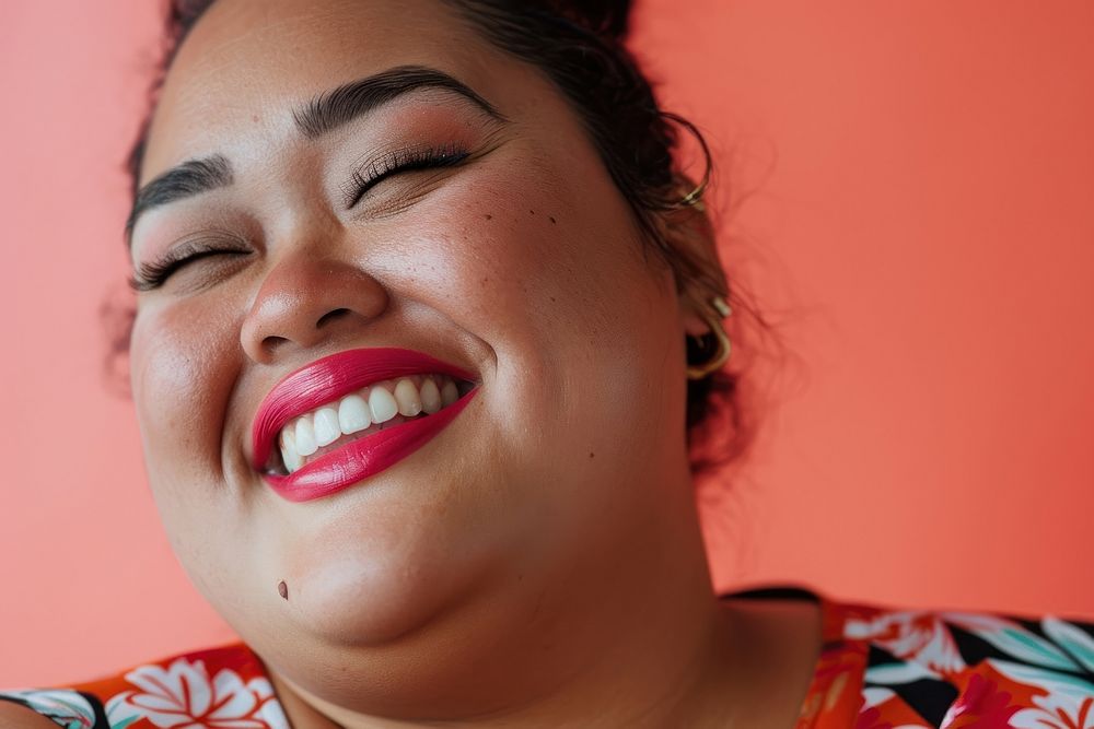 A chubby Tonga womans with cosmetic laughing adult smile.