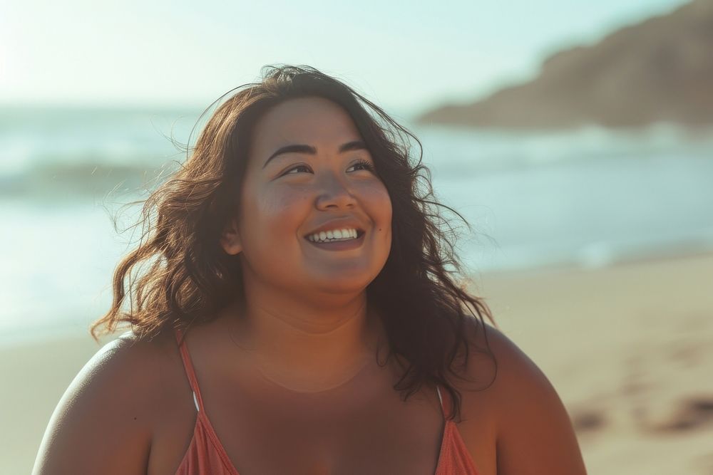 Chubby Pacific Islander woman walk on the beach outdoors laughing swimwear.
