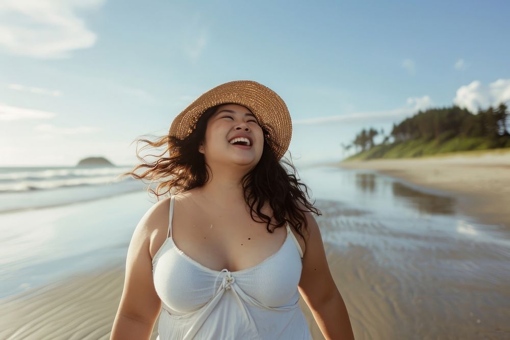 Chubby Pacific Islander woman walk on the beach outdoors laughing portrait.
