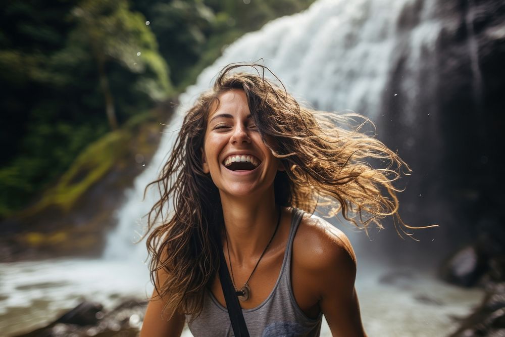 Columbian woman waterfall laughing outdoors.
