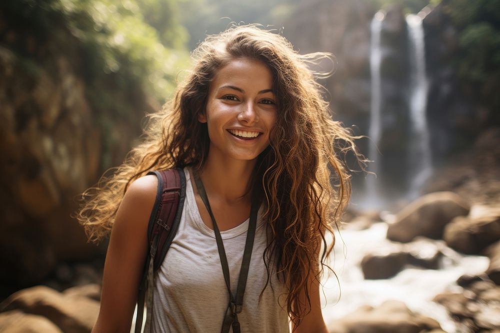 Columbian woman waterfall outdoors smiling.