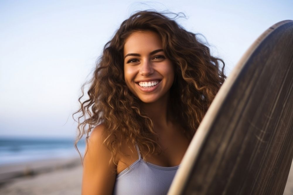 Latina outdoors surfboard laughing.