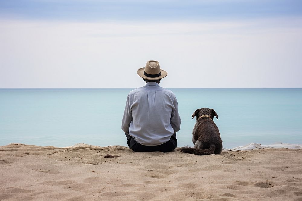Man and white dog sitting at beach outdoors horizon nature.