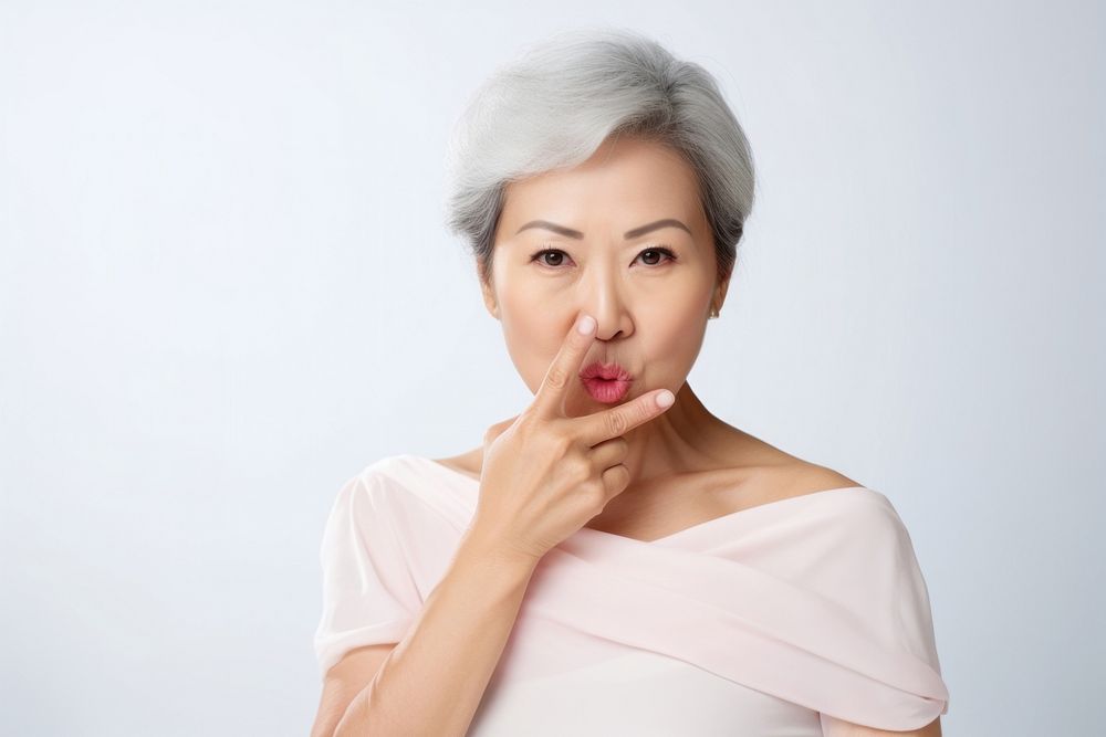 Asian woman keep quiet gesture adult contemplation perfection.