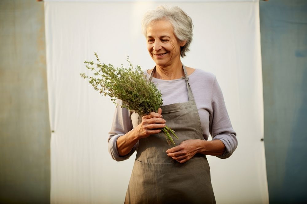 Woman holding Thyme herbs adult retirement happiness.