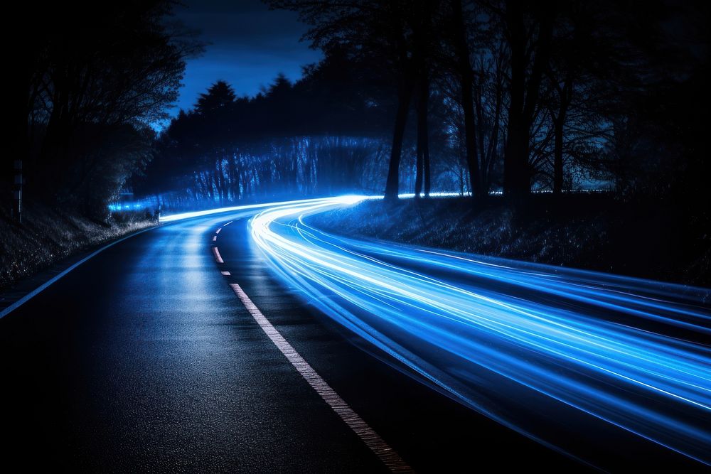 Blue car lights outdoors highway night.