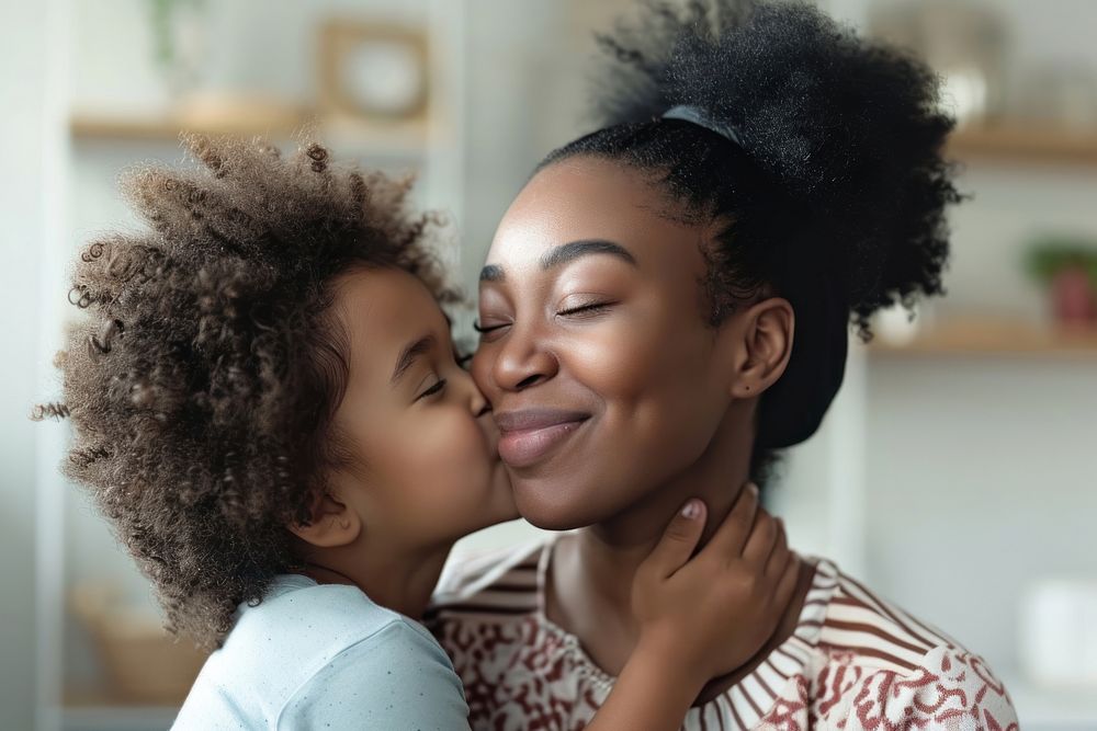 Black female child kissing cheerful portrait adult.