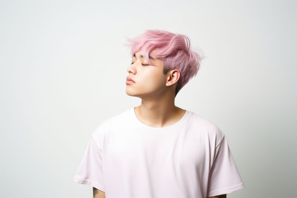 Man in white t-shirt pink hair white background.