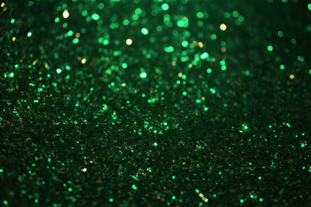 Green glitter background backgrounds illuminated defocused.