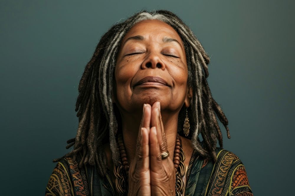 Black woman dreadlocks meditating portrait.