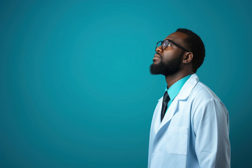 African Male doctor looking up with arms crossed adult photo male.