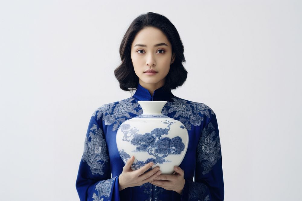 Woman holding porcelain vase adult dress blue.