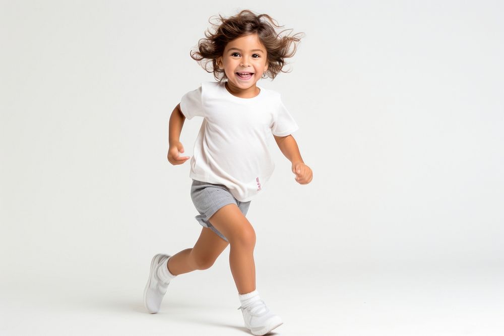 Child running shorts white background exercising.