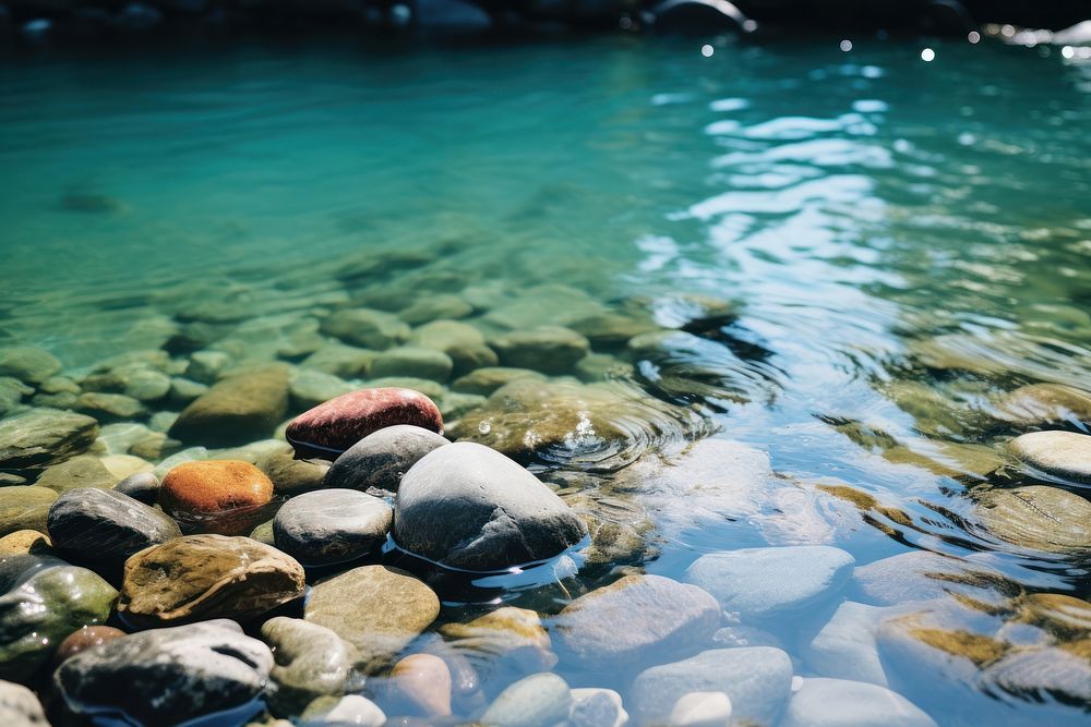 Pebbles and stones arranged in the water of a river pebble outdoors nature. AI generated Image by rawpixel.