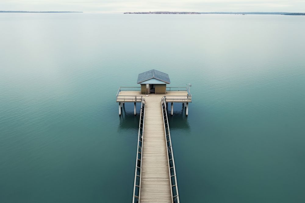 Drone view of pier over lake outdoors nature bridge. AI generated Image by rawpixel.