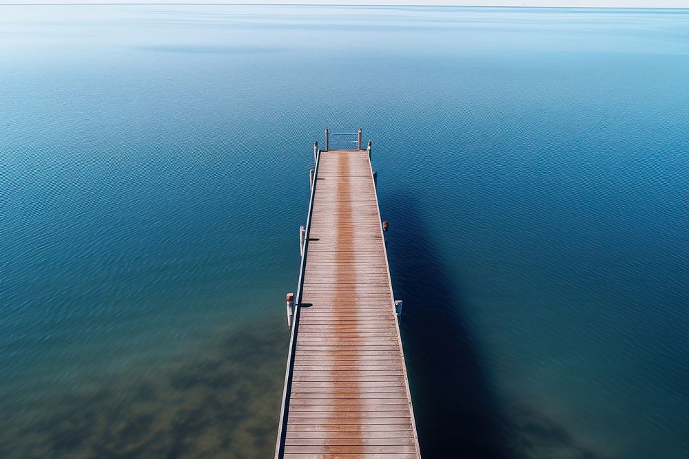 Drone view of pier over lake outdoors nature architecture. AI generated Image by rawpixel.