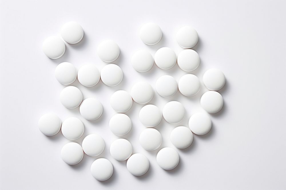White round pills white background medication abundance. AI generated Image by rawpixel.