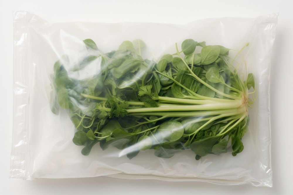 Plastic wrapping over a vegetable spinach plant food.