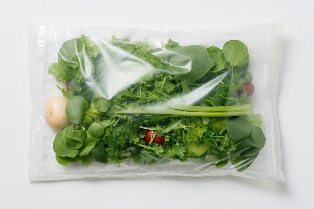 Plastic wrapping over a vegetable plant herbs food.