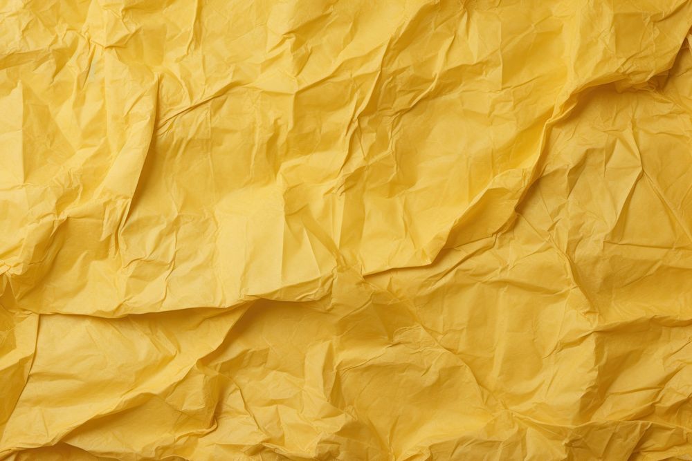Old yellow crumpled paper backgrounds parchment textured.
