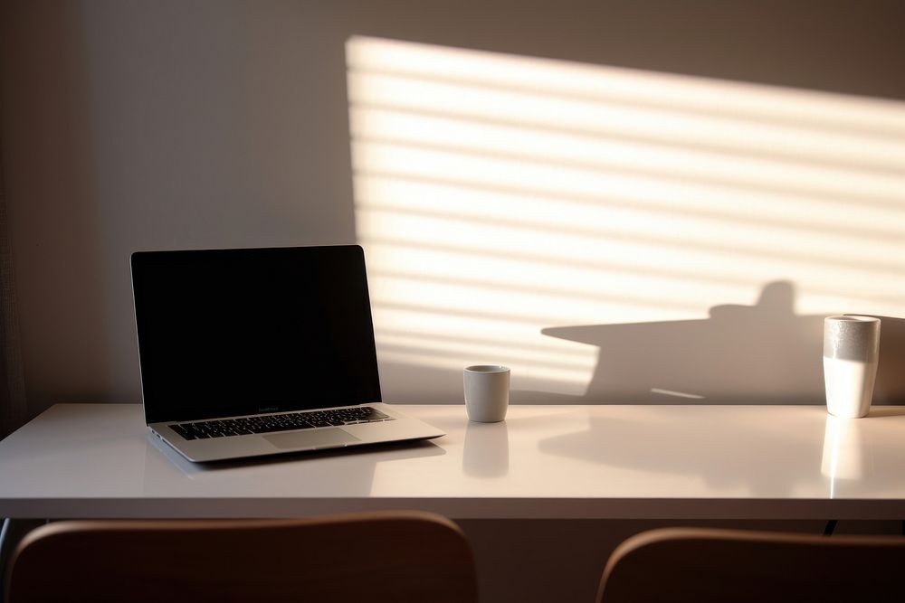 Computer white wallpaper on working desk furniture laptop table.