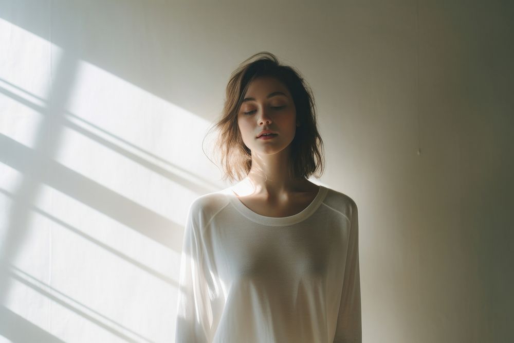 Women wear a white sweater with happy face adult contemplation hairstyle.