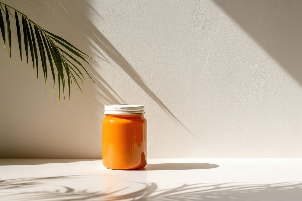 White jam jar with orange refreshment preserves container.