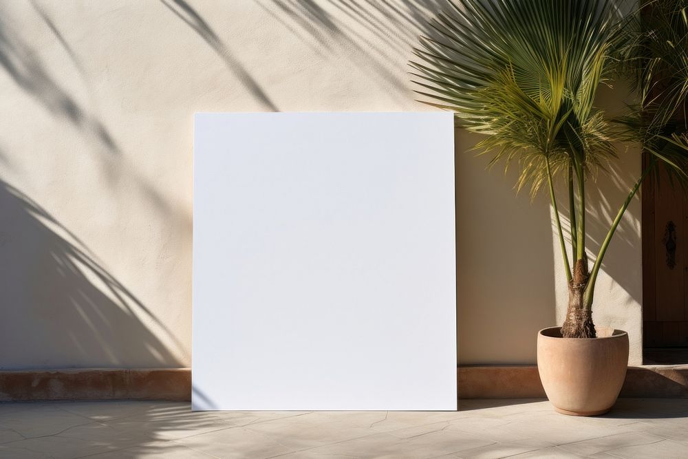A white poster printed on a wall architecture plant rectangle.