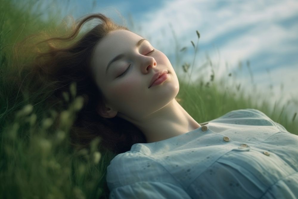 A girl sleep comfortably on green meadow sleeping portrait grass. 