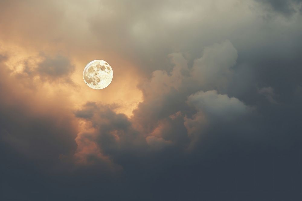 A full moon is seen through the clouds backgrounds astronomy outdoors.
