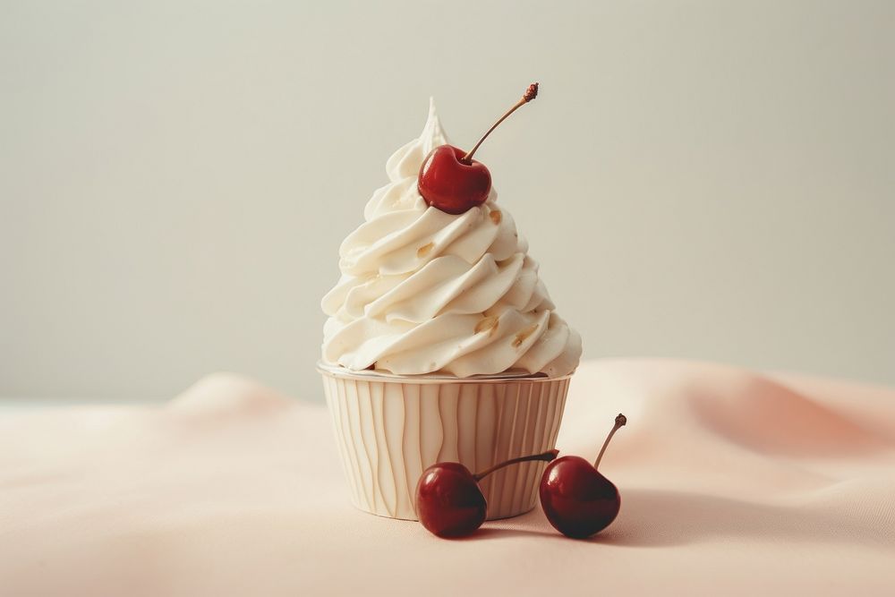 A ice cream cup with whipped cream and a cherry on top dessert cupcake fruit.