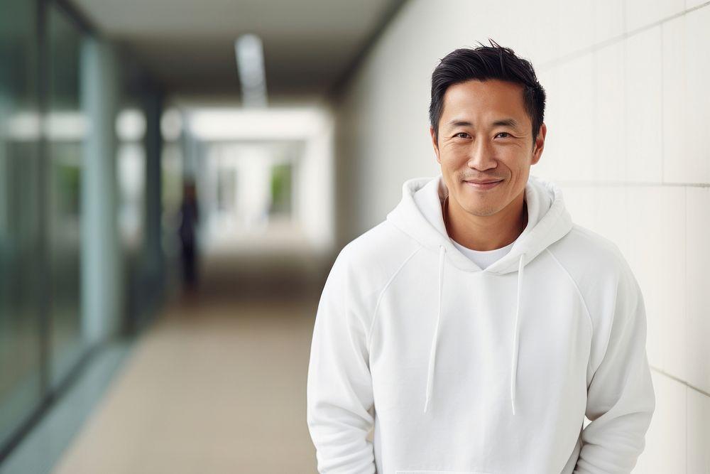 Happy asian american middle age man wearing white hoodie architecture adult smile.