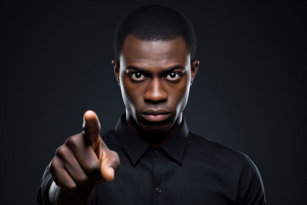 Serious dark skinned man with confident portrait finger adult.