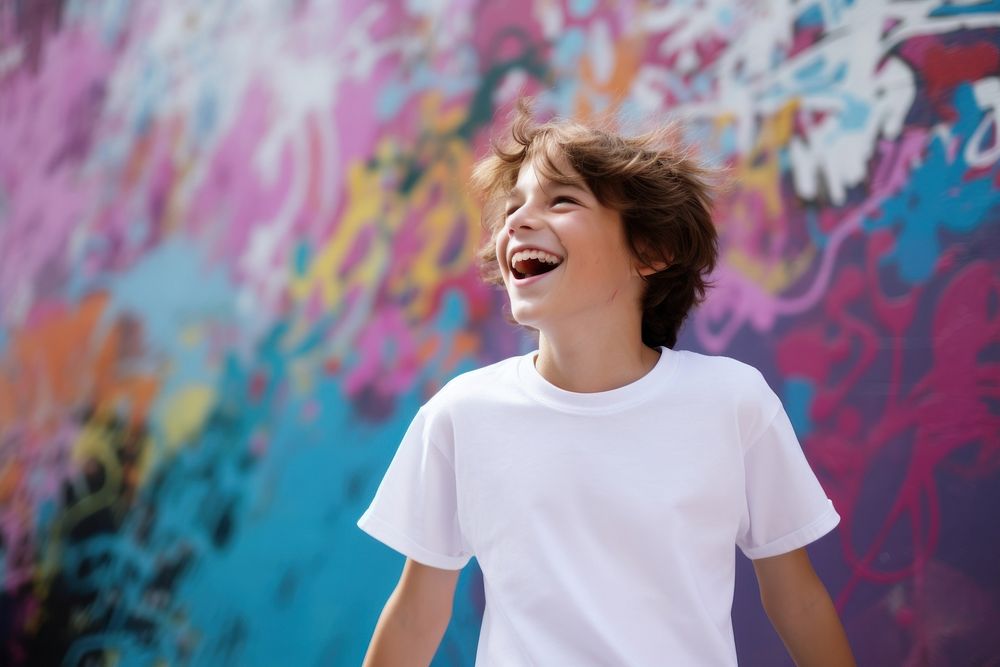 A kid wearing white t-shirt laughing fun individuality.
