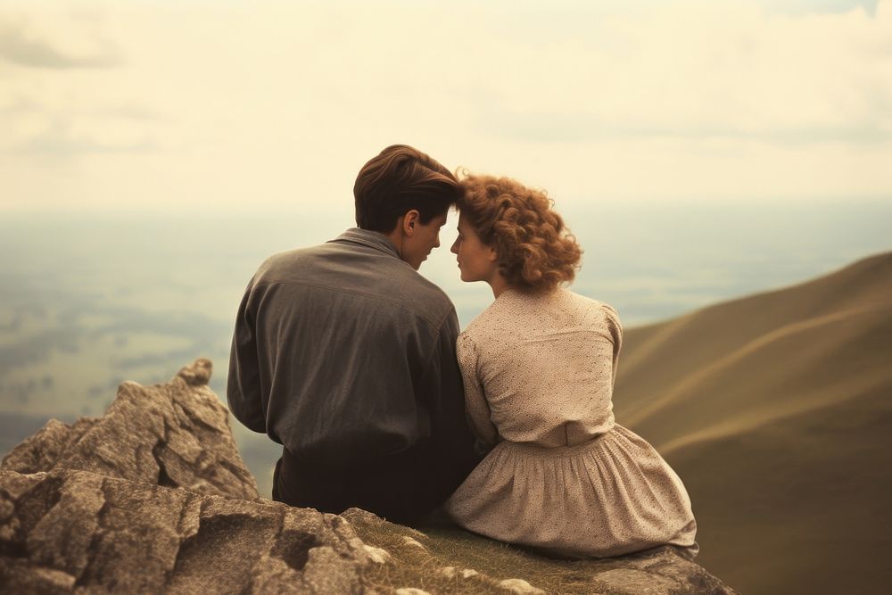 A couple sitting cutely on a mountain film photography landscape outdoors.
