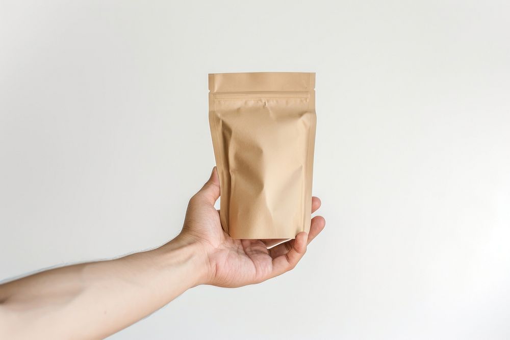 Coffee pouch bag holding hand white background.